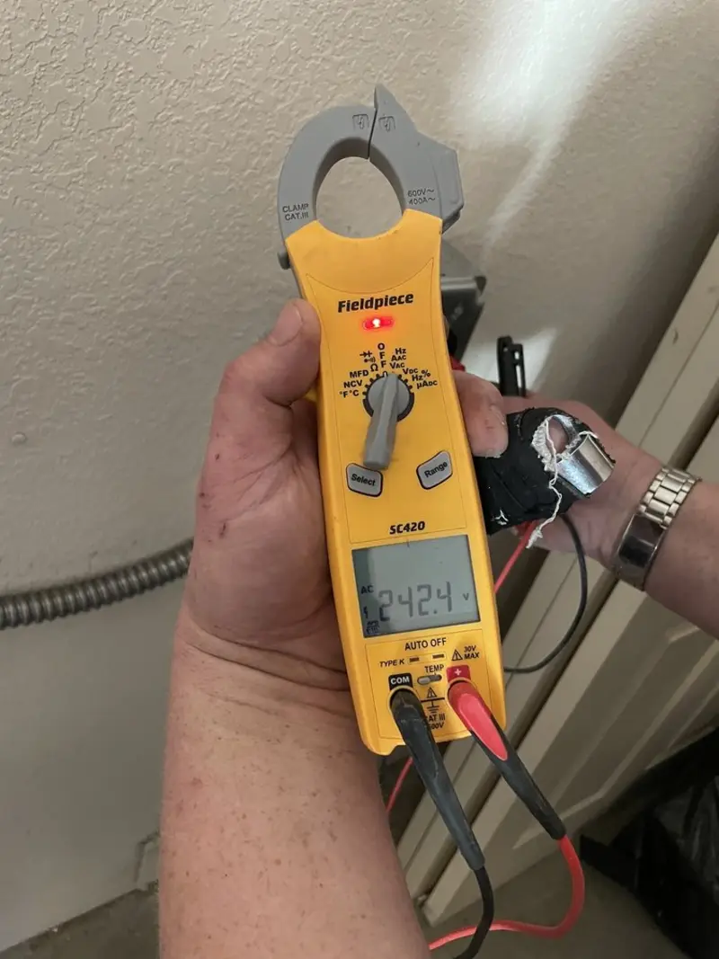 Voltage testing with clamp meter during Ceiling Fan Installation in East Marlborough